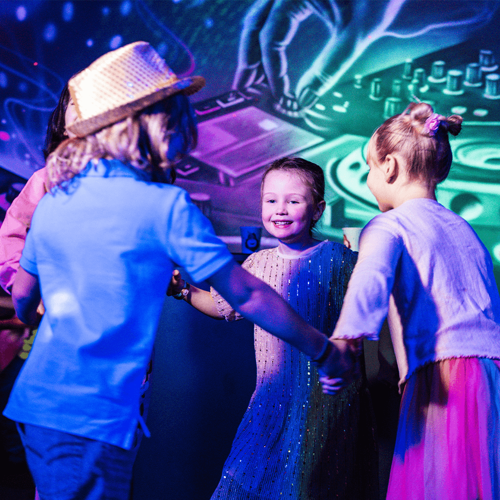Disco themed kids birthday party at Leo's – children dancing in the party room