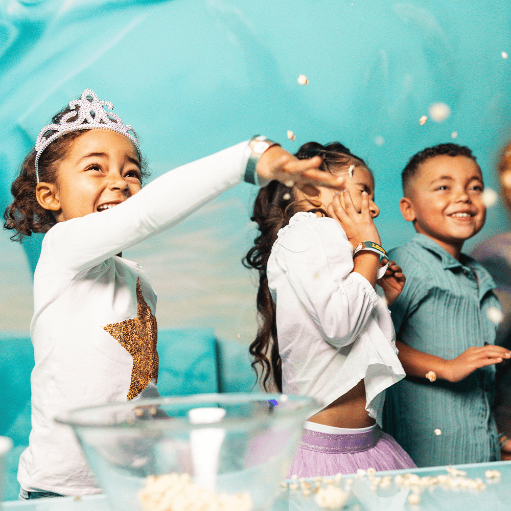 Popcorn flying through the air as children have fun at a kids birthday party at Leo's